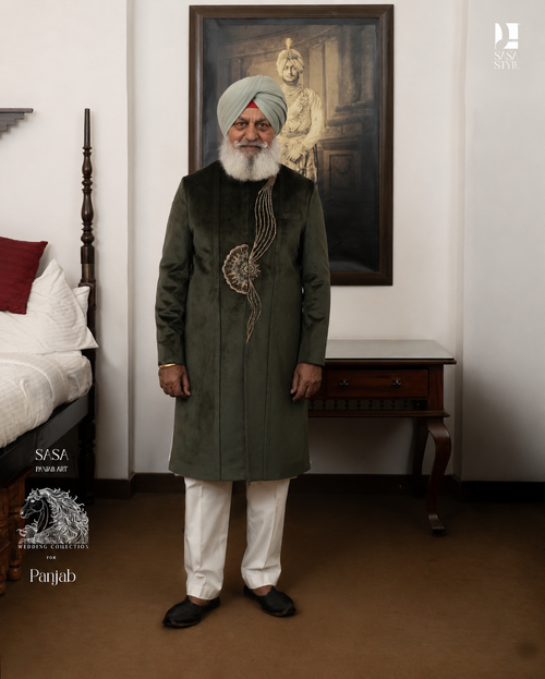 A regal bottle green achkan crafted with finesse, featuring intricate detailing